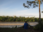 student on the bank of the Amazon river