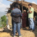 Author talking with disaster-affected community members